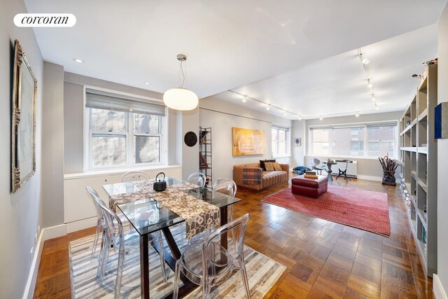 dining space with baseboards, rail lighting, visible vents, and recessed lighting