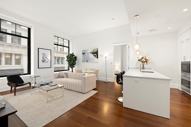 living area with baseboards and dark wood-style flooring
