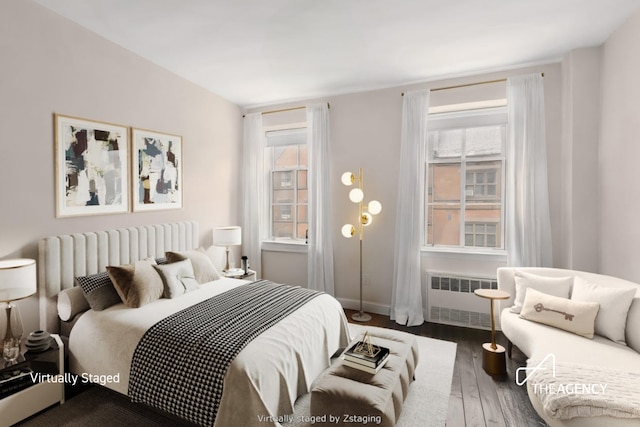 411 W 21st St Unit 3Flr, New York City, NY 10011 - bedroom with radiator and wood finished floors