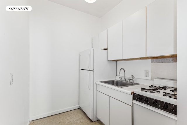 kitchen with white appliances, a sink, white cabinetry, light countertops, and baseboards