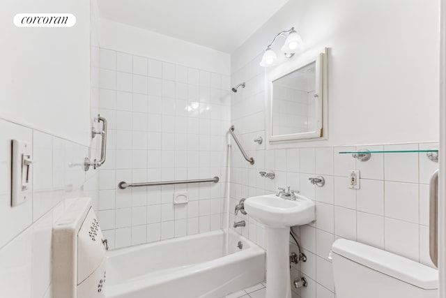 full bathroom featuring tile walls, toilet, and shower / washtub combination