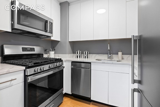 7 E 14th St Unit 429, New York City, NY 10003 - kitchen featuring stainless steel appliances, a sink, and modern cabinets