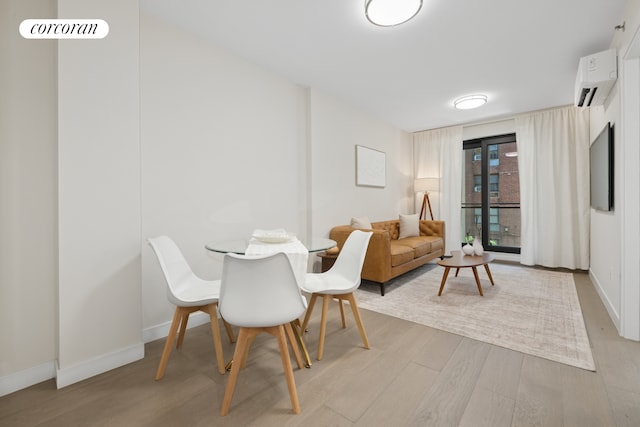 608 Ocean Ave Unit 403, New York City, NY 11226 - dining room with a wall mounted air conditioner, light wood-type flooring, and baseboards