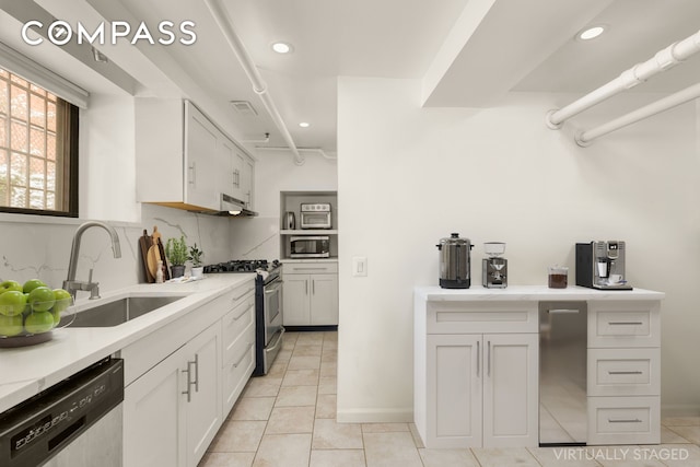184 Clinton Ave Unit Garden1, New York City, NY 11205 - kitchen featuring stainless steel appliances, light countertops, light tile patterned floors, recessed lighting, and white cabinetry