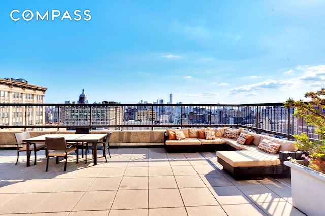view of patio with outdoor dining area, a city view, and an outdoor hangout area