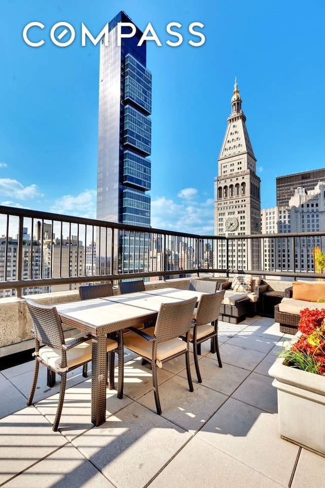 view of patio featuring a view of city and outdoor dining area