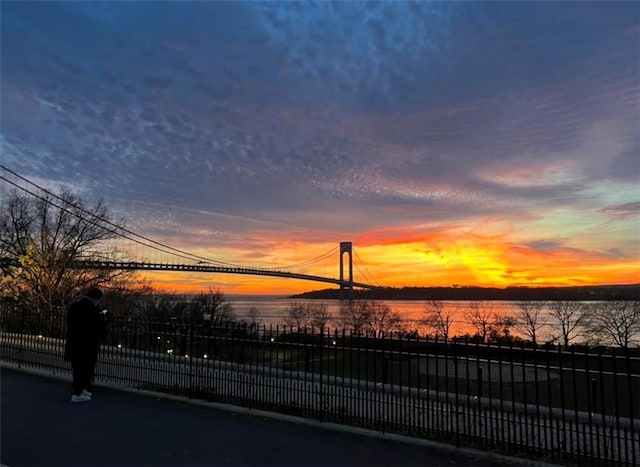 water view featuring fence and a notable bridge