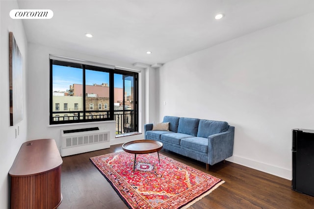 living area featuring visible vents, recessed lighting, radiator, and wood finished floors