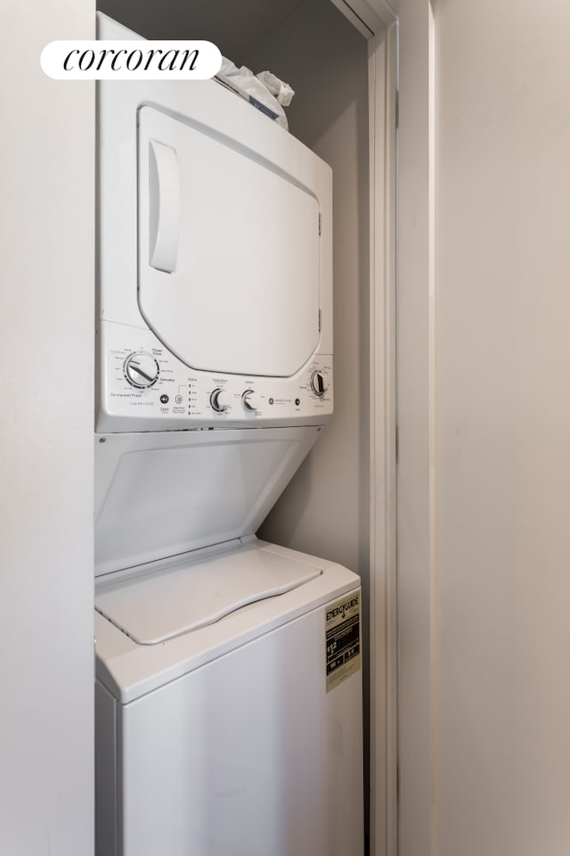 laundry area with laundry area and stacked washer / drying machine