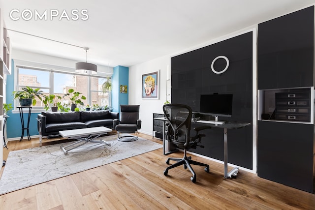 home office featuring wood finished floors and baseboards