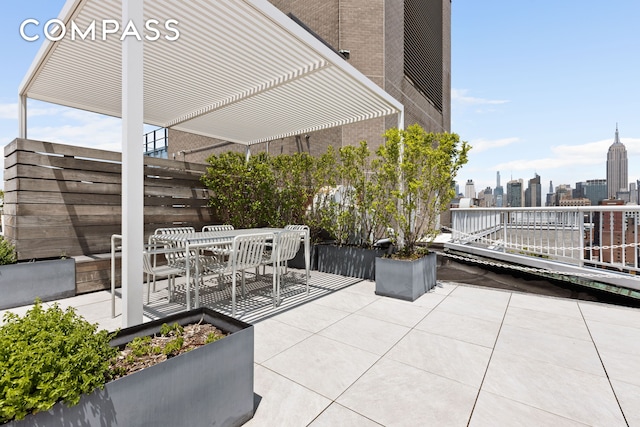 101 W 12th St Unit 9D, New York City, NY 10011 - view of patio featuring a skyline view, outdoor dining area, and a pergola