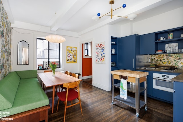 1 W 67th St Unit 309, New York City, NY 10023 - dining space featuring beam ceiling, dark wood-style flooring, and a chandelier