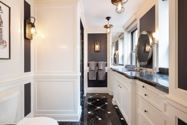 220 E 73rd St Unit 6Cde, New York City, NY 10021 - bathroom featuring vanity, toilet, marble finish floor, and a decorative wall