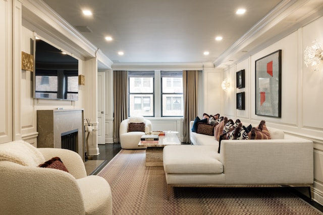 220 E 73rd St Unit 6Cde, New York City, NY 10021 - living room featuring crown molding, recessed lighting, a fireplace, and a decorative wall