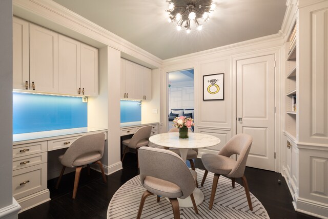 220 E 73rd St Unit 6Cde, New York City, NY 10021 - dining room with an inviting chandelier, crown molding, dark wood-style flooring, and built in desk
