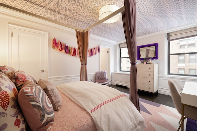 220 E 73rd St Unit 6Cde, New York City, NY 10021 - bedroom featuring crown molding, wainscoting, wood finished floors, and an ornate ceiling