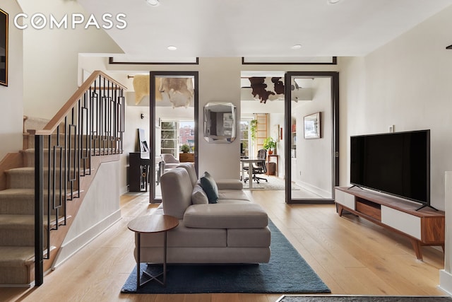 240 W 23rd St Phc, Phc, New York City, NY 10011 - living area with light wood-type flooring, stairs, recessed lighting, and baseboards