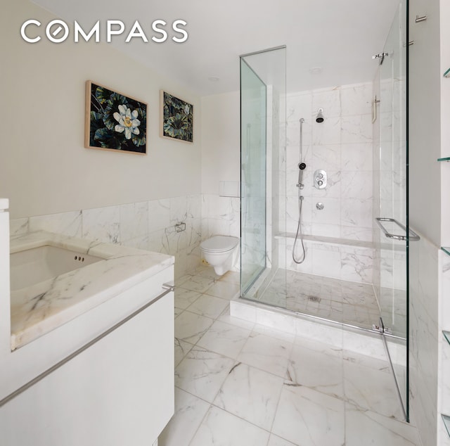 240 W 23rd St Phc, Phc, New York City, NY 10011 - bathroom with toilet, marble finish flooring, a marble finish shower, vanity, and tile walls