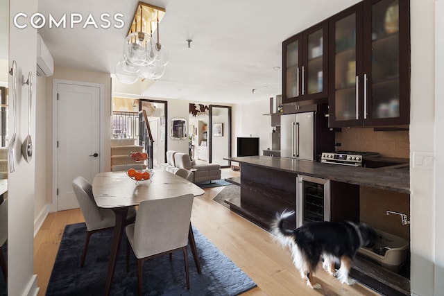 240 W 23rd St Phc, Phc, New York City, NY 10011 - dining room with light wood-type flooring, wine cooler, stairs, and an AC wall unit