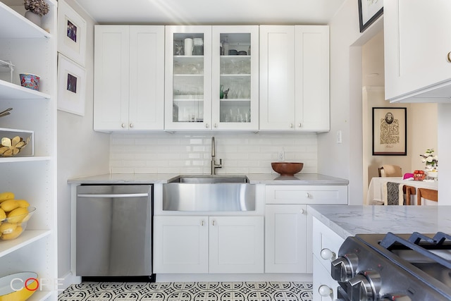 kitchen featuring range with gas cooktop, white cabinetry, stainless steel dishwasher, and a sink