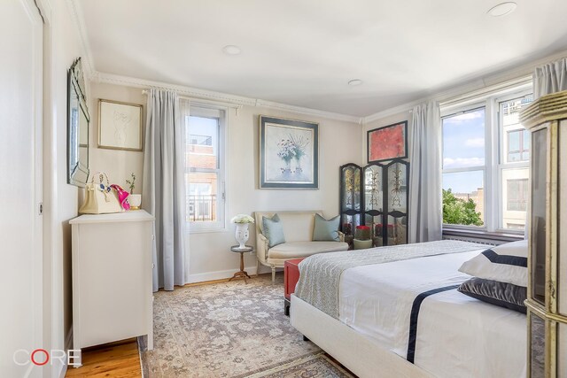 bedroom with crown molding, recessed lighting, baseboards, and light wood-type flooring
