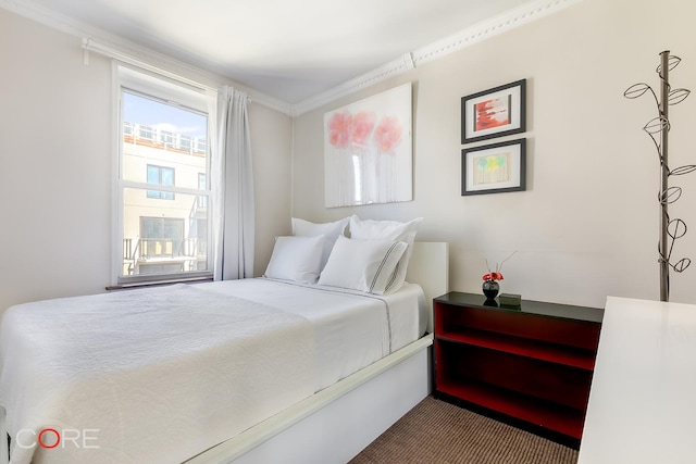 carpeted bedroom with ornamental molding