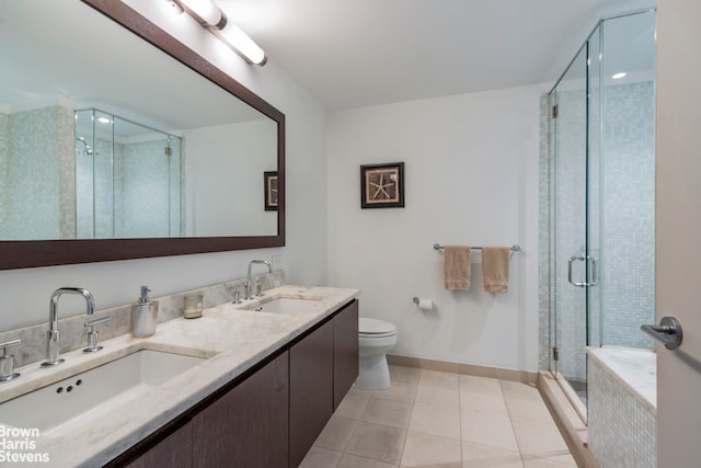 full bath featuring baseboards, a sink, a stall shower, and tile patterned flooring