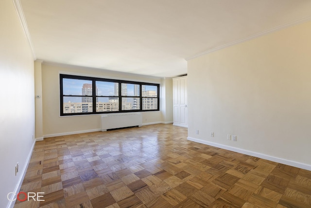 160 W End Ave Unit 28L, New York City, NY 10023 - spare room with radiator heating unit, baseboards, and ornamental molding