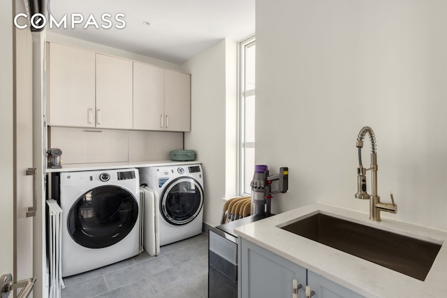 250 E 21st St Unit 10A, New York City, NY 10010 - laundry room with independent washer and dryer, cabinet space, and light tile patterned floors
