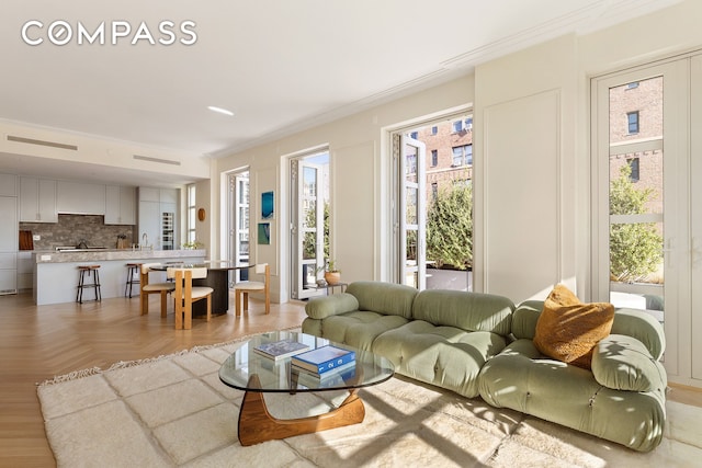 250 E 21st St Unit 10A, New York City, NY 10010 - living area featuring plenty of natural light and ornamental molding