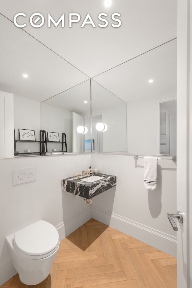 250 E 21st St Unit 10A, New York City, NY 10010 - half bathroom featuring baseboards, toilet, and vanity