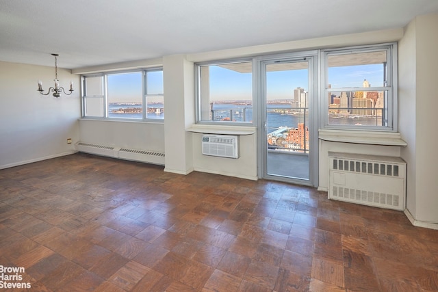 75 Henry St Unit 30K, New York City, NY 11201 - unfurnished living room featuring radiator heating unit, a baseboard radiator, a chandelier, an AC wall unit, and baseboards