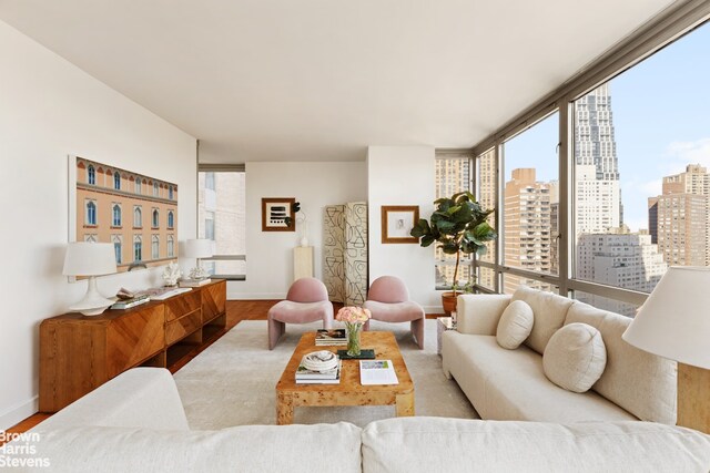 150 Columbus Ave Unit 18F, New York City, NY 10023 - living room with baseboards, wood finished floors, and a view of city