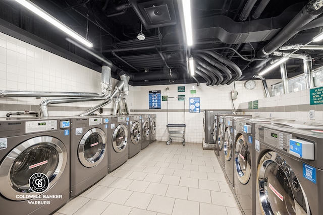 shared laundry area featuring tile patterned flooring and washer and dryer