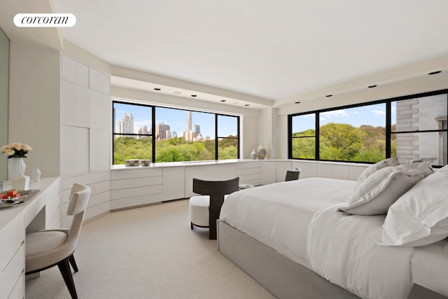 bedroom featuring visible vents, light colored carpet, and multiple windows