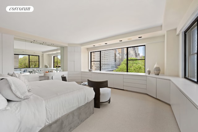 bedroom featuring visible vents and light colored carpet