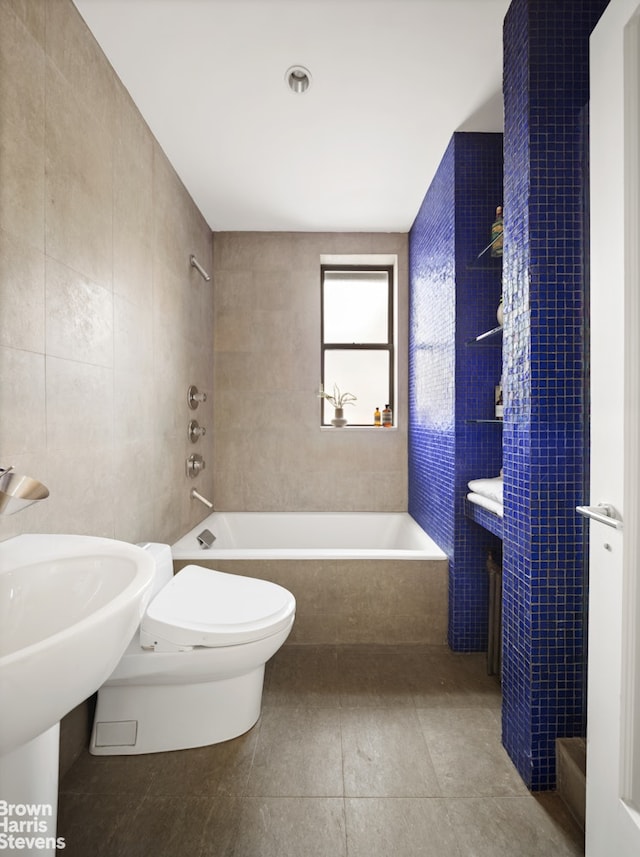 bathroom featuring tile patterned floors, tile walls, and toilet