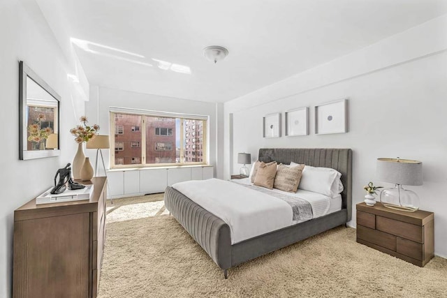 bedroom featuring light colored carpet