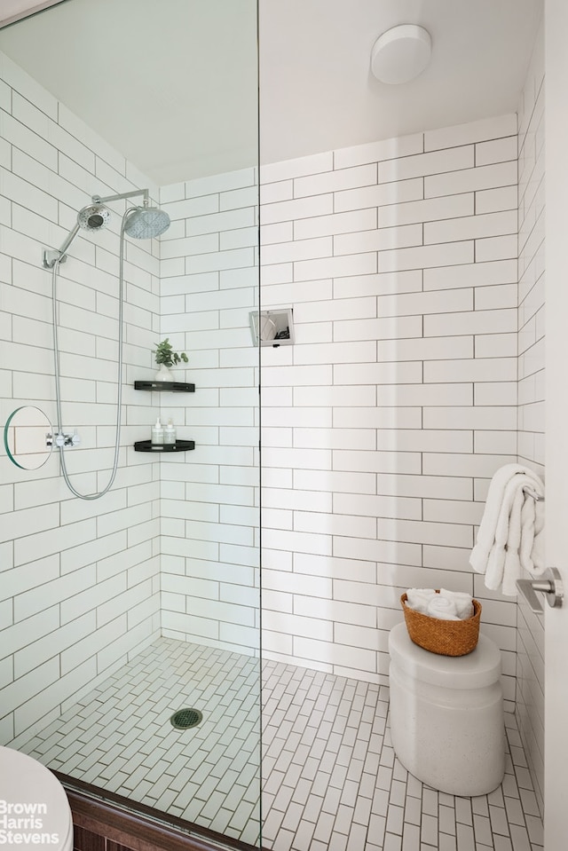 15 William St Unit 33I, New York City, NY 10004 - full bathroom with toilet, a shower stall, and tile walls