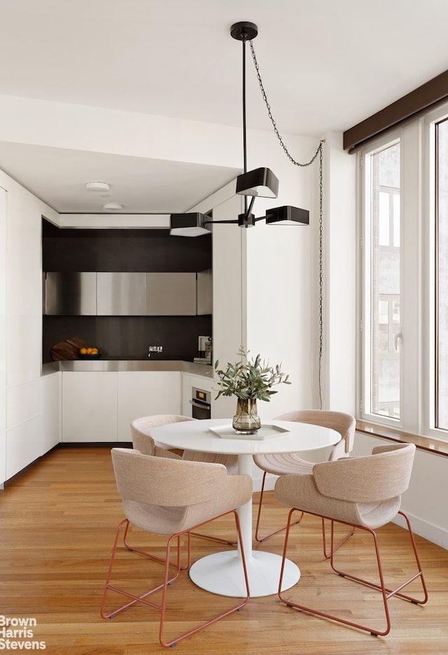 15 William St Unit 33I, New York City, NY 10004 - dining area with healthy amount of natural light and light wood finished floors
