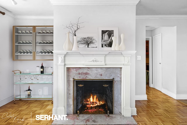detailed view of a premium fireplace, baseboards, and crown molding