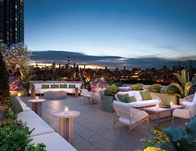 24-01 Queens Plz N Unit 201, New York City, NY 11101 - patio terrace at dusk with an outdoor living space with a fire pit