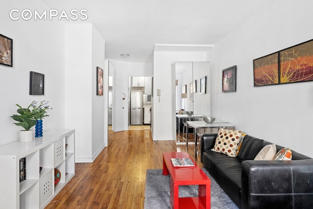 205 E 89th St Unit 4C, New York City, NY 10128 - living area featuring wood finished floors and baseboards