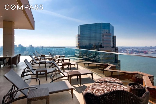 75 Wall St Unit 24M, New York City, NY 10005 - view of patio / terrace with a balcony, a city view, and a water view