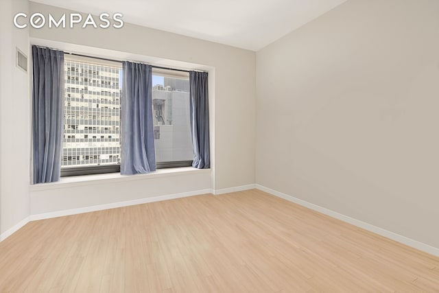 75 Wall St Unit 24M, New York City, NY 10005 - spare room with wood finished floors and baseboards
