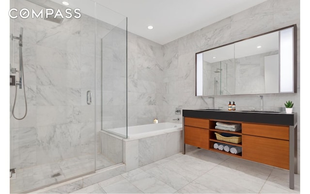 75 Wall St Unit 24M, New York City, NY 10005 - full bathroom with a marble finish shower, a bath, vanity, marble finish floors, and recessed lighting