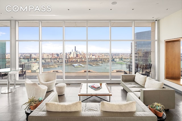 75 Wall St Unit 24M, New York City, NY 10005 - living room with floor to ceiling windows, a view of city, and tile patterned flooring