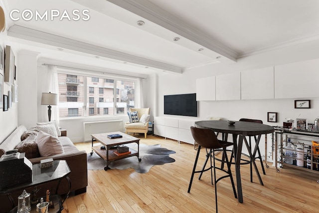 201 E 25th St Unit 7F, New York City, NY 10010 - living area featuring crown molding, light wood-style flooring, and beamed ceiling