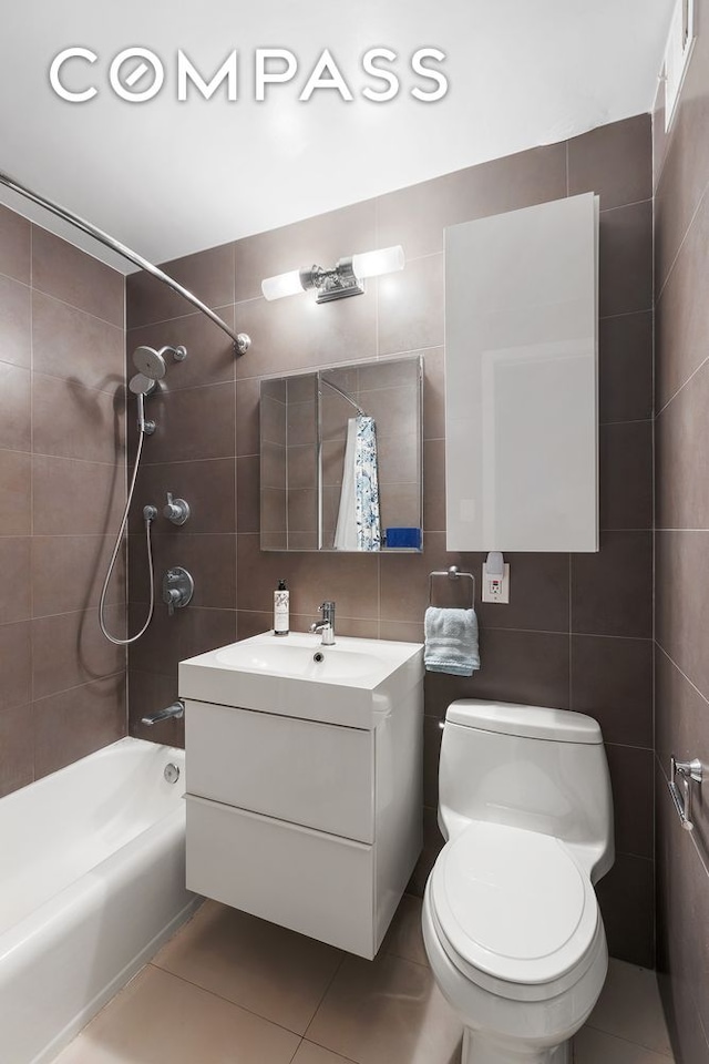 201 E 25th St Unit 7F, New York City, NY 10010 - bathroom featuring tile walls, vanity, toilet, shower / bath combo, and tile patterned flooring