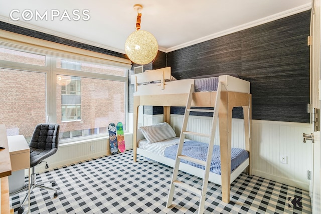 400 E 67th St Unit 3Cd, New York City, NY 10065 - bedroom with multiple windows, a desk, wainscoting, and ornamental molding